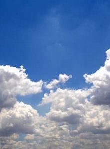 Blue sky at the top of the photo with white clouds underneath