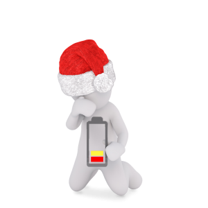 Person with a Santa hat on and a battery in front of them running quite low, nearing empty